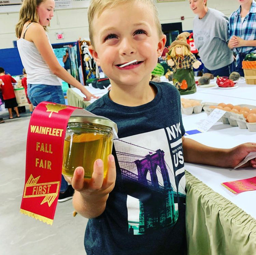 Mason with his first place ribbon for the best golden honey at the Wainfleet Fair.